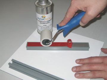 Indasol UHB-9120G Channel Fixing Tape being applied with a roller